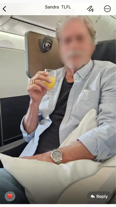 Sandra's husband enjoying Business Class with mimosa in hand
