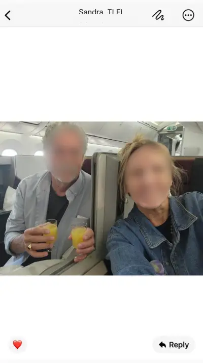 Sandra and partner cheers-ing with mimosas onboard Business Class